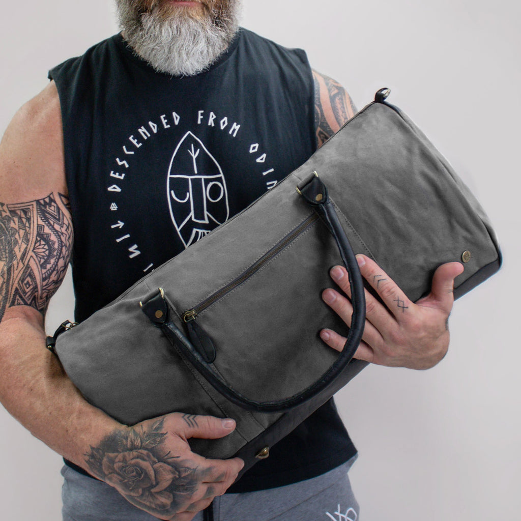 https://mahileather.com/cdn/shop/products/personalised-gym-bag-grey-canvas-black-leather-duffle-bag-2_1024x.jpg?v=1601296997